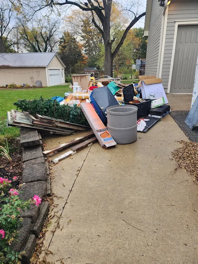 Dumpster being loaded with debris for Estate Cleanout Dumpster Rental in Ranchettes